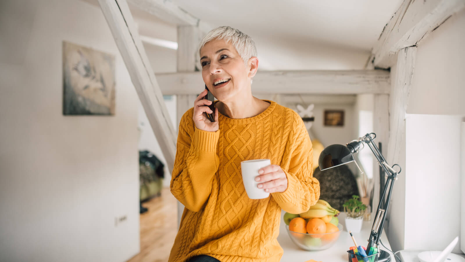 Happy older woman using mobile phone and smiling