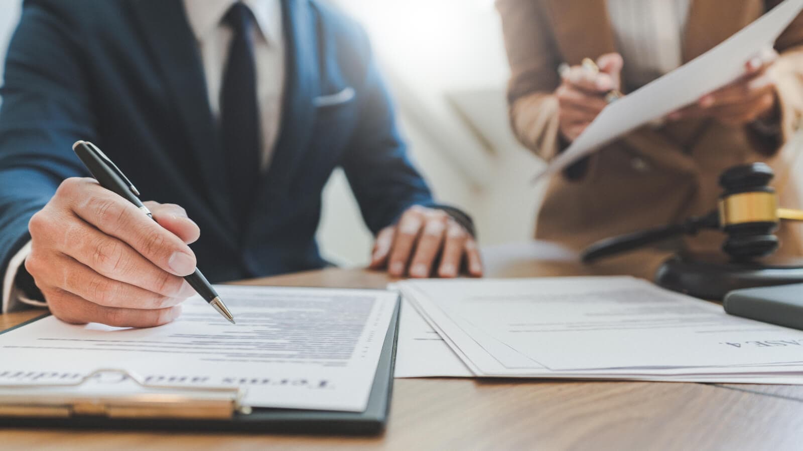 Lawyer working with coworker on table