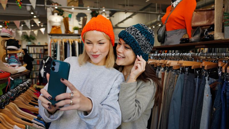 Two young women in a vintage clothes store