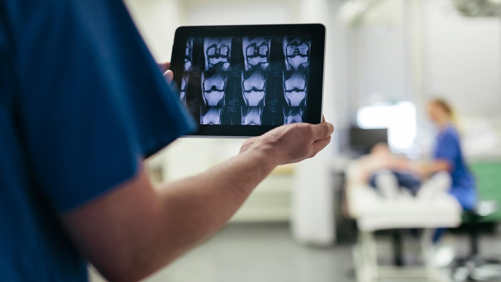 Doctor showing MRI images on digital tablet