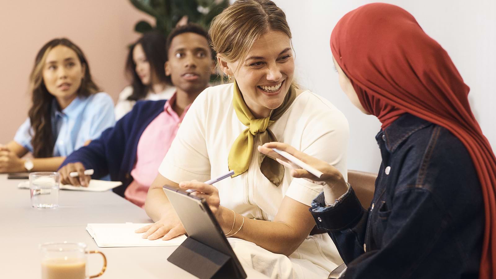 Two women discussing ideas in a team meetin